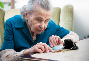 Woman counting coins on table