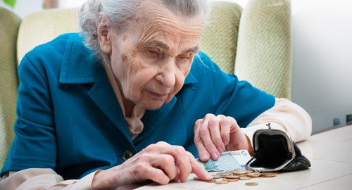 Woman counting coins on table